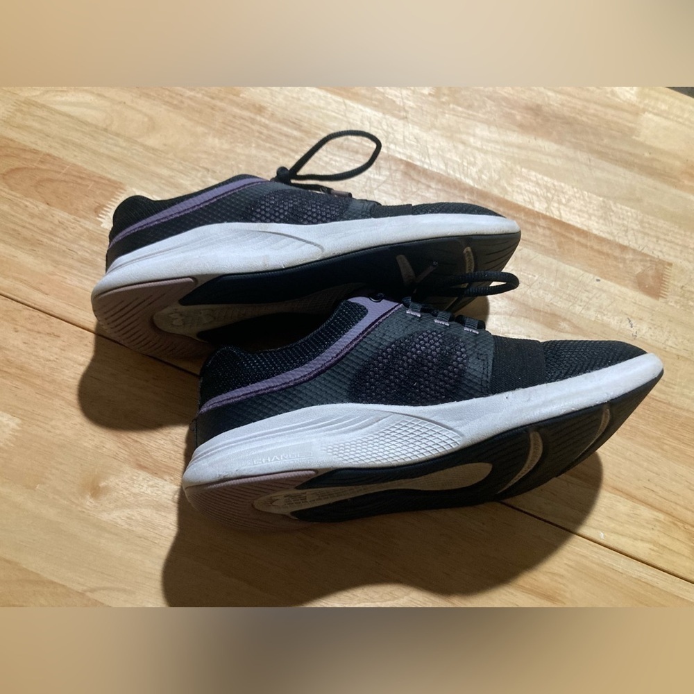 Under Armour sneakers in size 7.5 in EUC. Black & white with purple accents